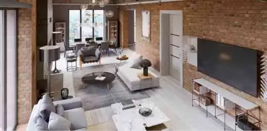Grand appartement moderne de style loft avec canapés, fauteuil, cheminée, mur en briques, table à manger.